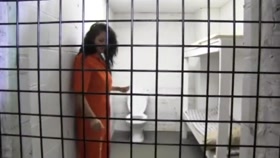Cuffed Inmate in Prison